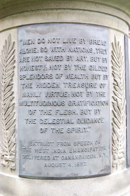 Plaque 1 at base of statue: MEN DO NOT LIVE BY BREAD ALONE...